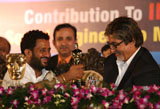 Resul Pukootty is ecstatic as he shows off his Oscar trophy to Amitabh Bachchan at an award ceremony.